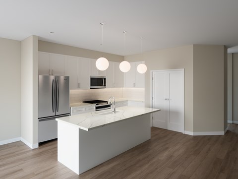 A modern kitchen with a white island and stainless steel appliances.