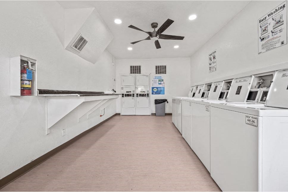 a laundry room with white appliances and a ceiling fan