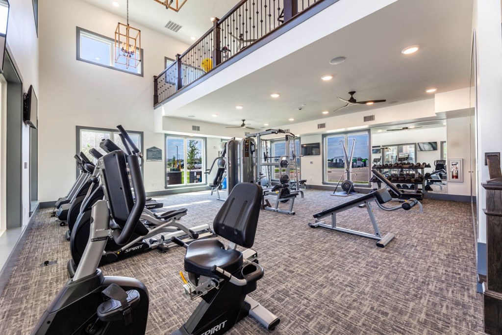 A spacious home gym with a variety of exercise equipment.