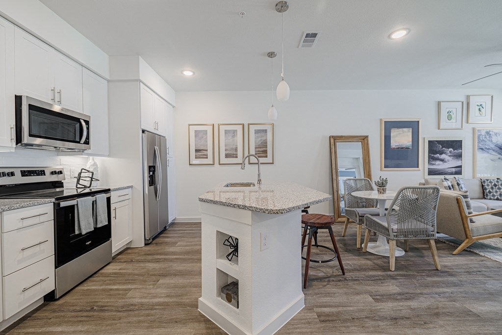 a kitchen and living room with a table and chairs
