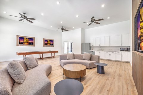 A living room with a grey couch and a wooden table.