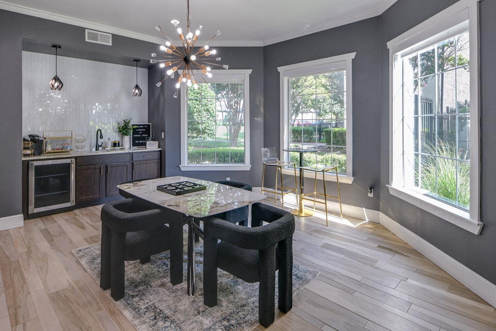 a dining area with a table and chairs and a chandelier