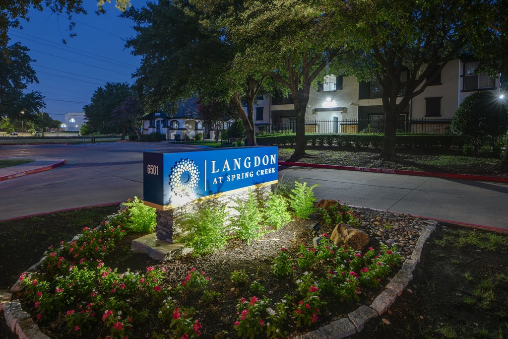 a nighttime view of the leasing office sign