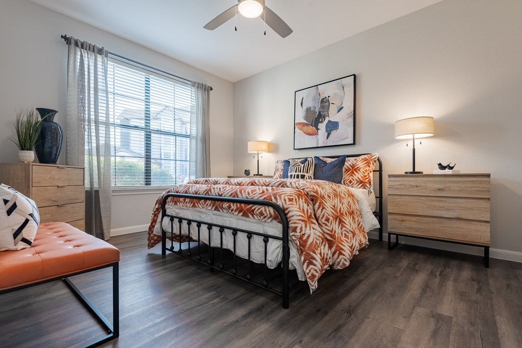 a bedroom with a bed and a ceiling fan