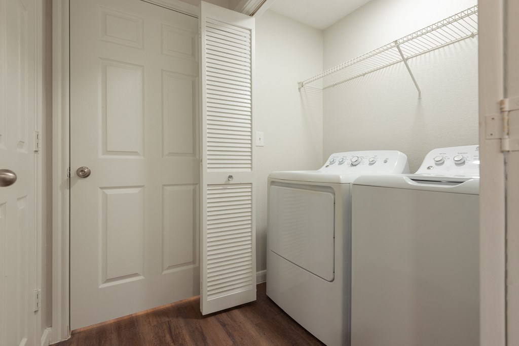 a laundry room with a washer and dryer and a closet