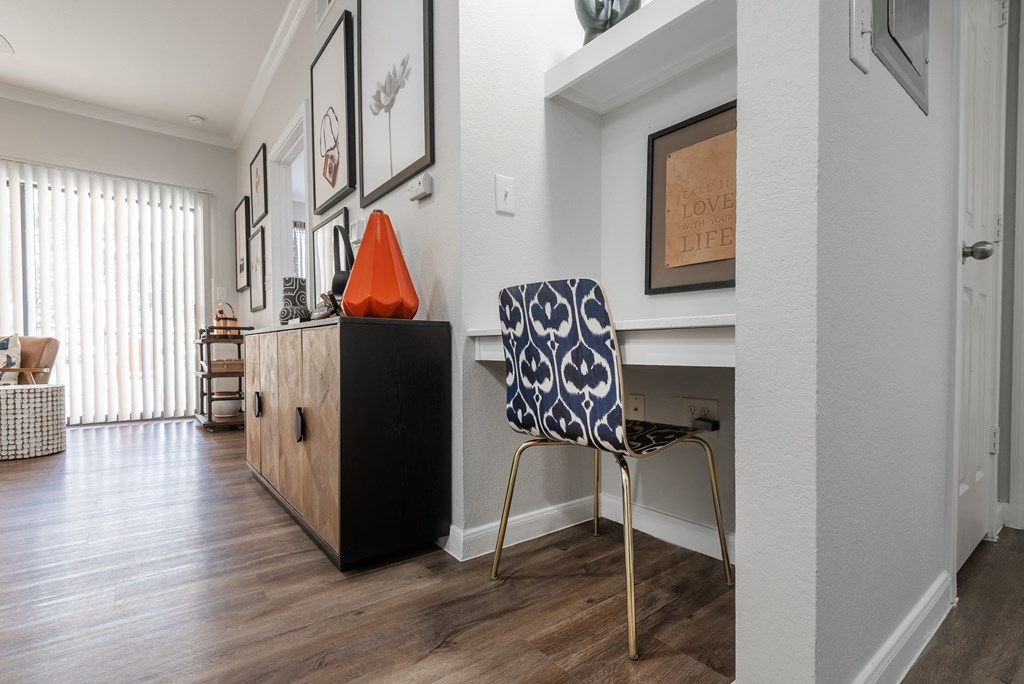 a home office with a chair and a desk in a living room