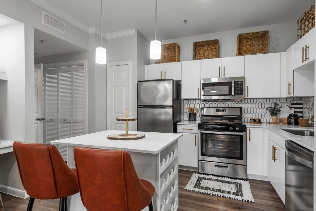 a kitchen with stainless steel appliances and a white counter top