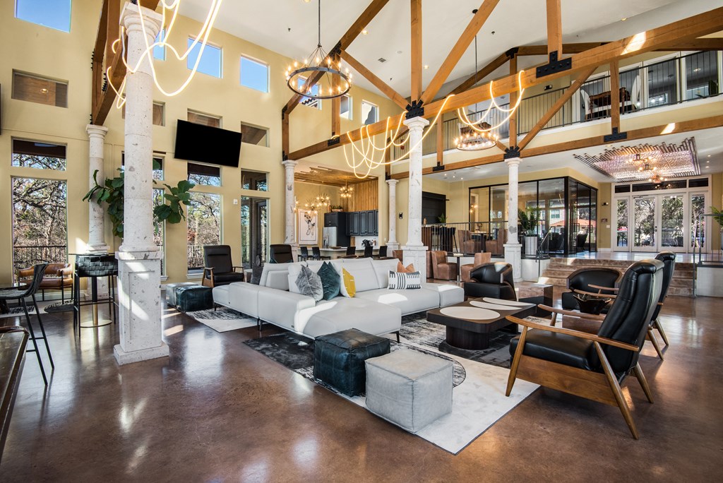 a large living room filled with furniture and chandeliers
