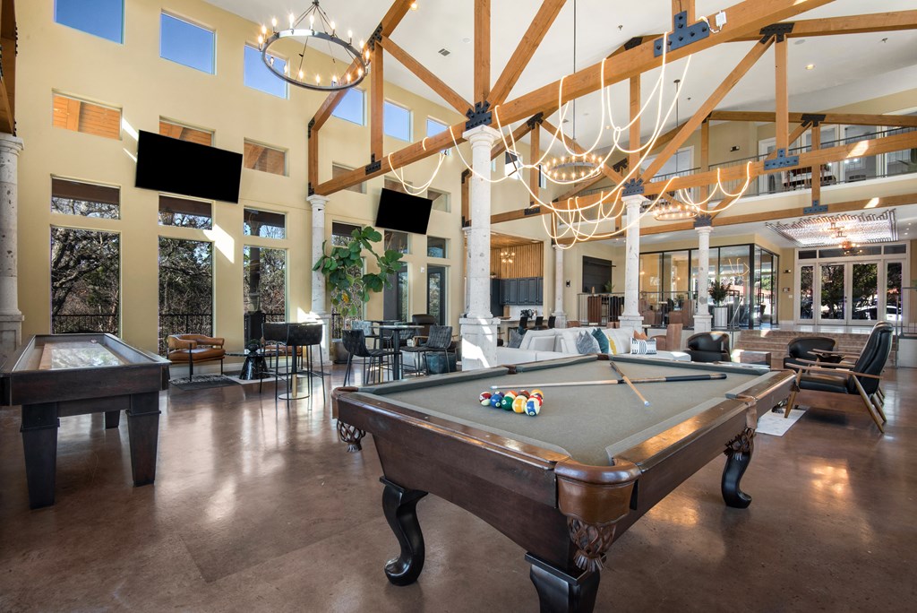a large clubhouse with a pool table and a ping pong table