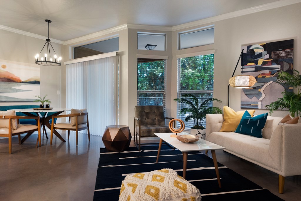 a living room and dining room with a table and chairs