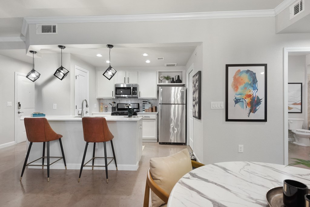 a kitchen and dining area in a 555 waverly unit