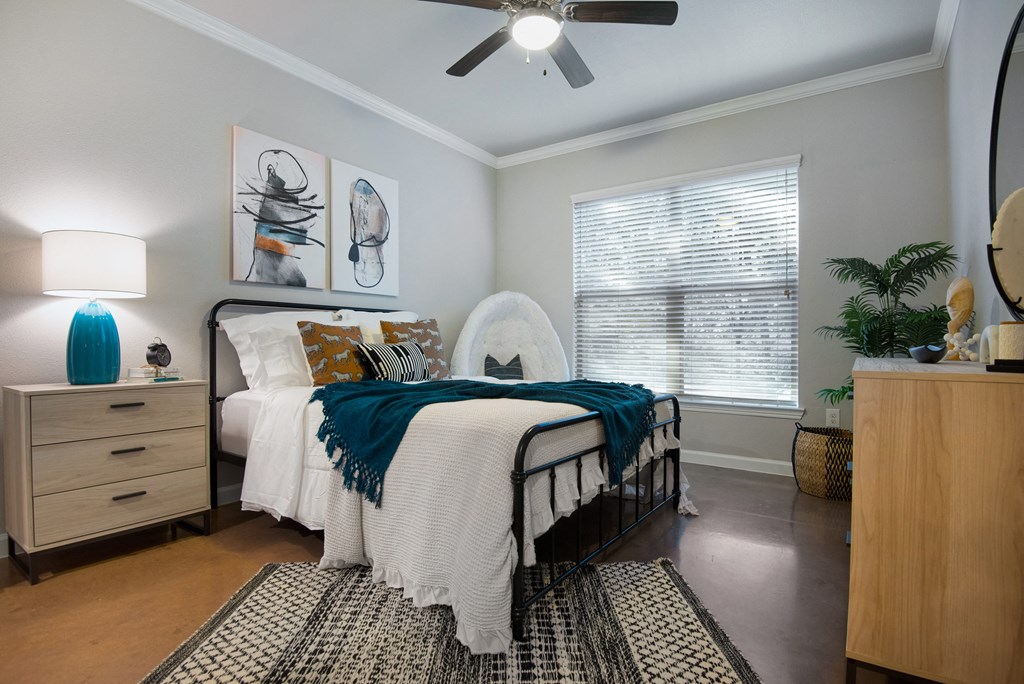 a bedroom with a bed and a ceiling fan