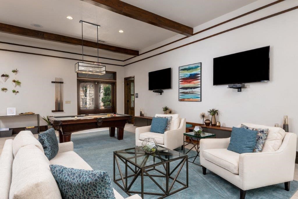 game room with white sofas