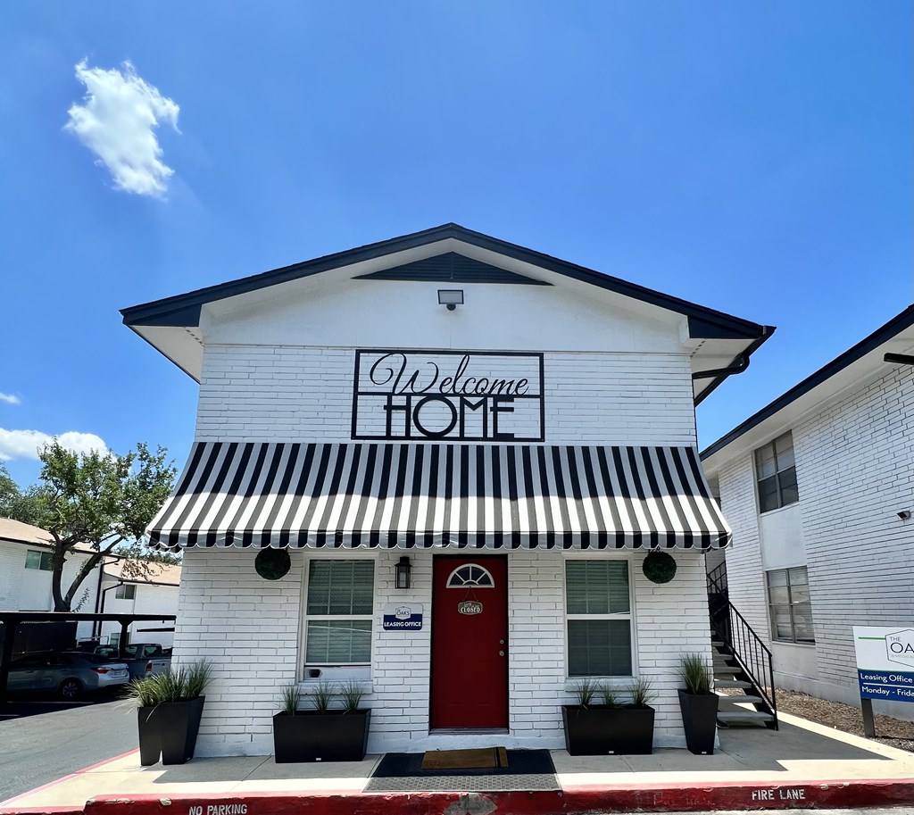 the facade of the welcome home building with a red door