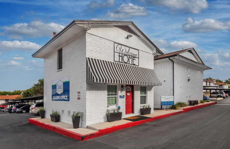 a white building with a sign that readscottage hotel