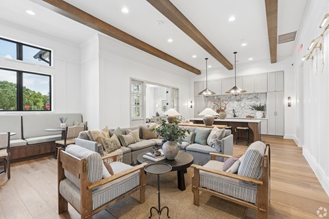 A living room with a grey couch and a wooden chair.