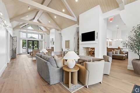 A spacious living room with a fireplace and a television.