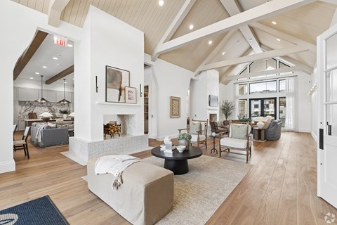 A spacious living room with a large couch and a fireplace.