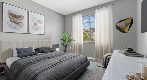 A bedroom with a large bed and a painting on the wall.