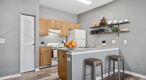 A kitchen with wooden cabinets and a white refrigerator.