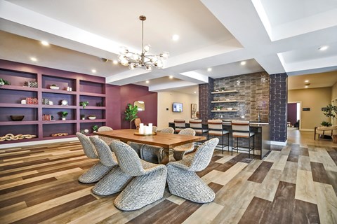 A modern dining room with a wooden table and chairs.