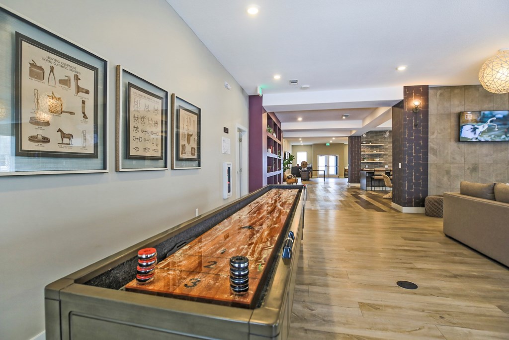 A shiny pool table with red and black balls on it.