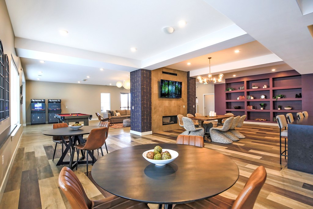 A modern living room with a fireplace and a dining table.
