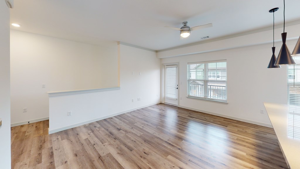 A room with wooden flooring and a ceiling fan.