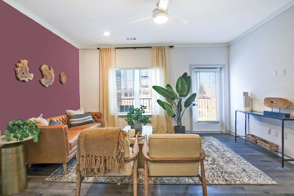 A living room with a brown chair and a brown couch.