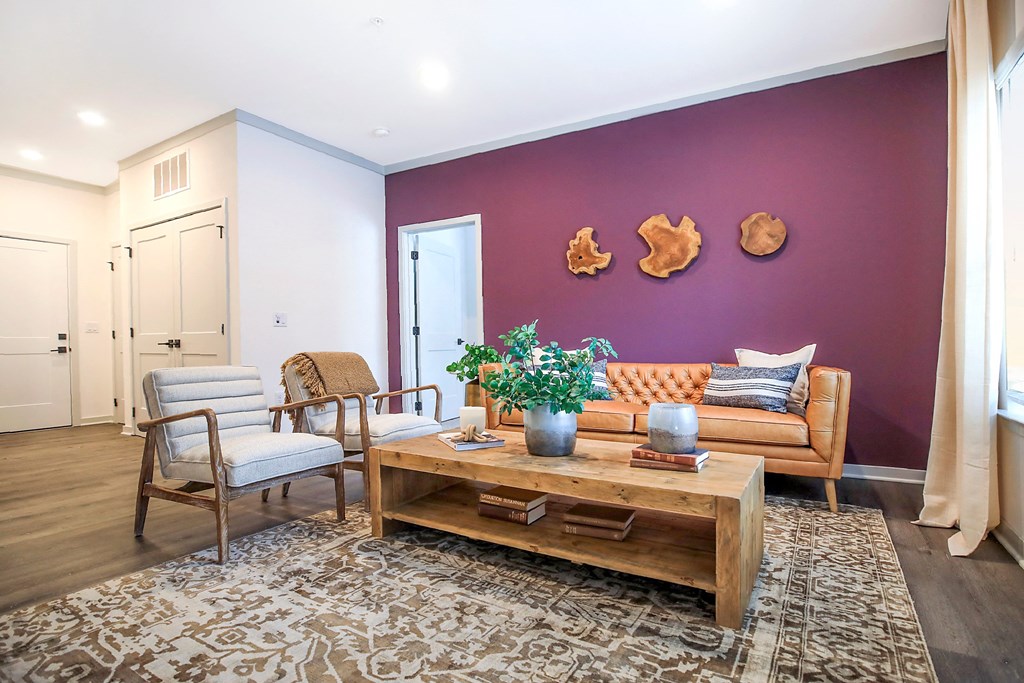 a living room with purple walls and a wooden coffee table