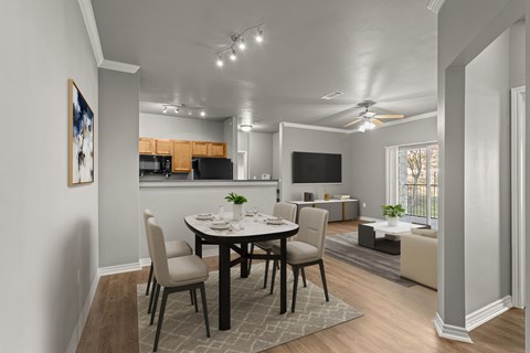 A dining room with a table set for four.