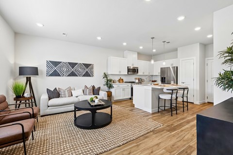 A modern living room with a white couch and a black coffee table.