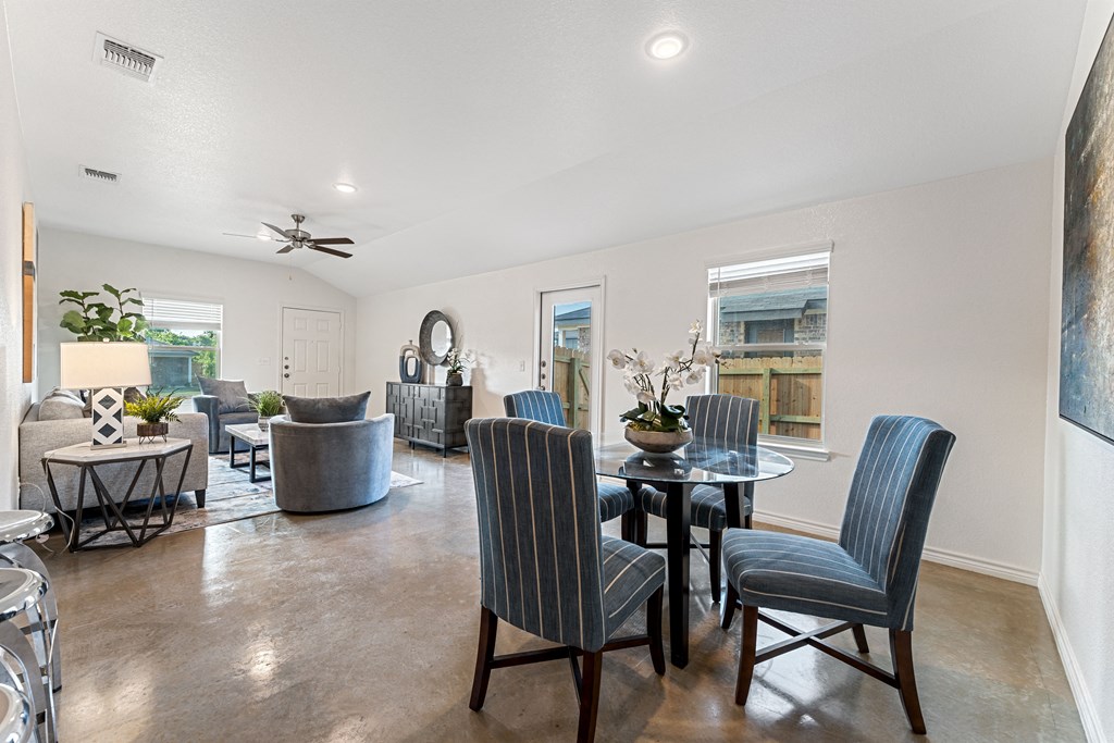 an open living room with a dining room table and chairs