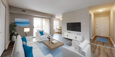 a living room with blue and white furniture and a tv