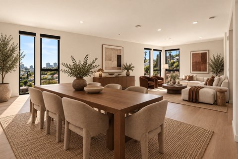 A dining room with a long table and chairs.
