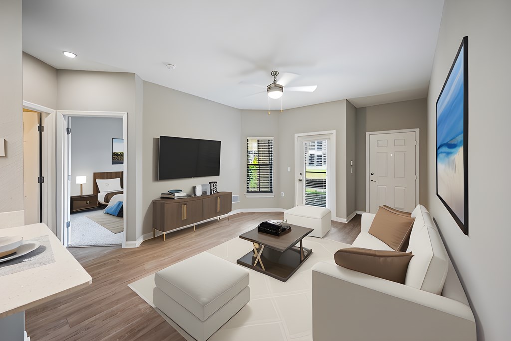 a white living room with a white couch and a television