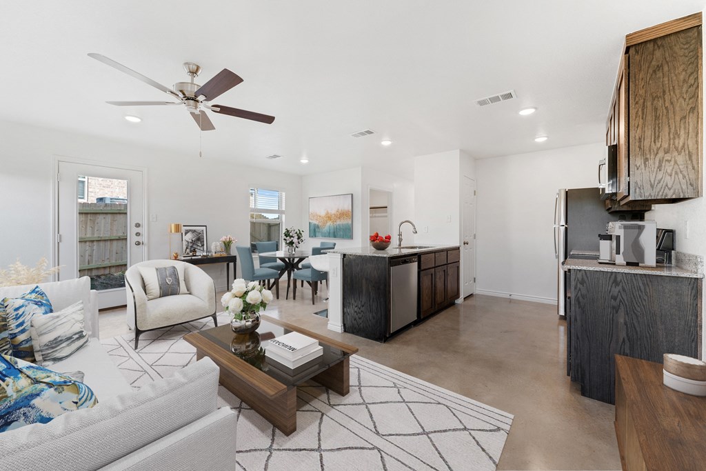 a living room with a kitchen and a dining room