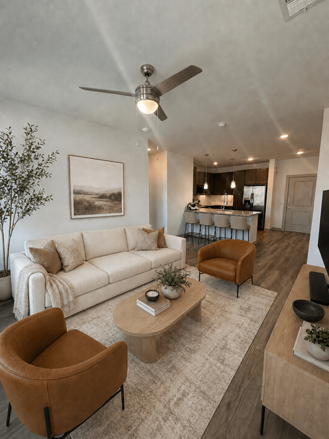 A living room with a white couch, brown armchair, and a coffee table.