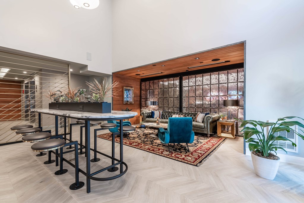 A modern living room with a bar area and a view of the outdoors.