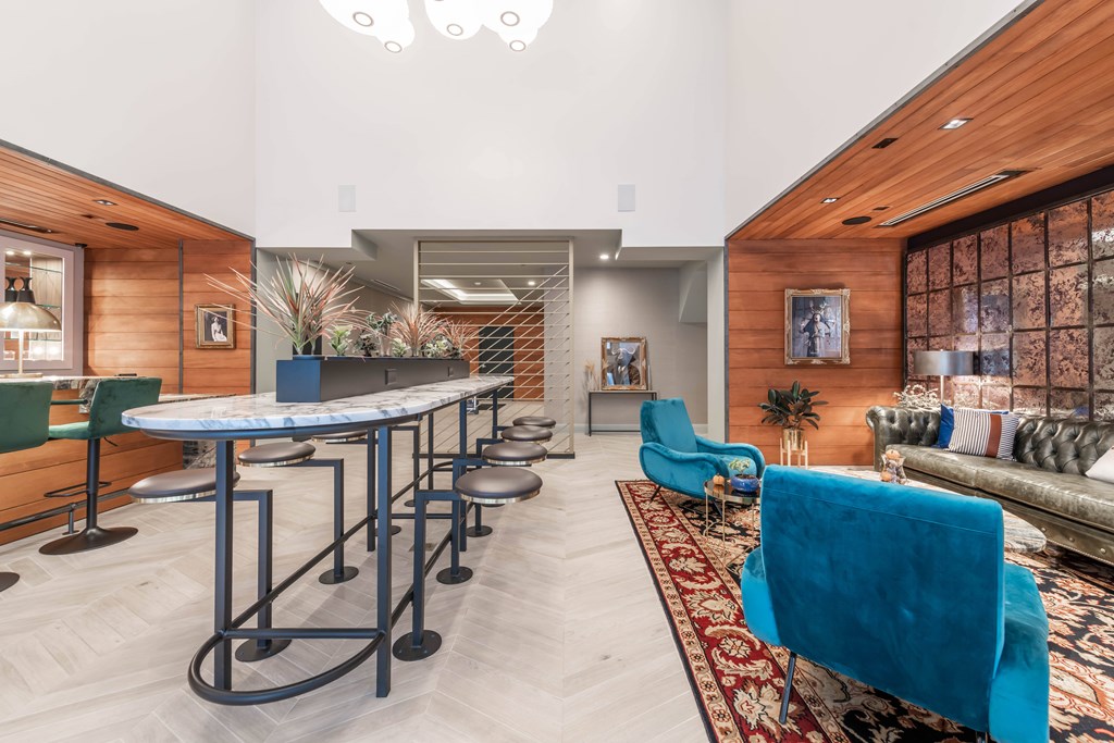 A room with a long table and blue chairs.