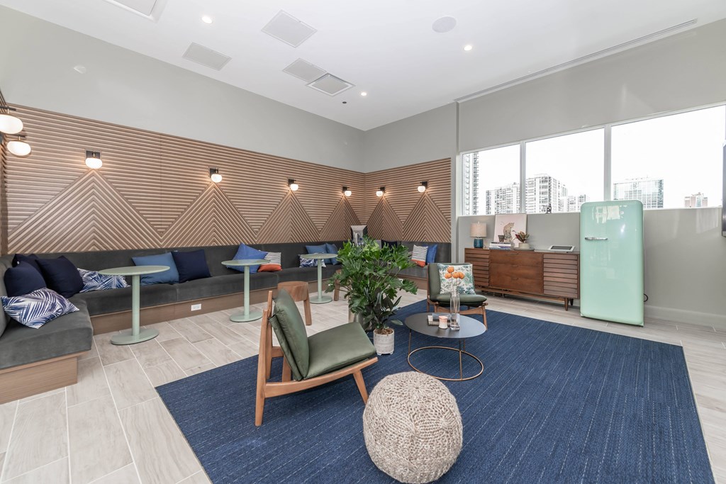 A modern living room with a blue rug and a wooden chair.