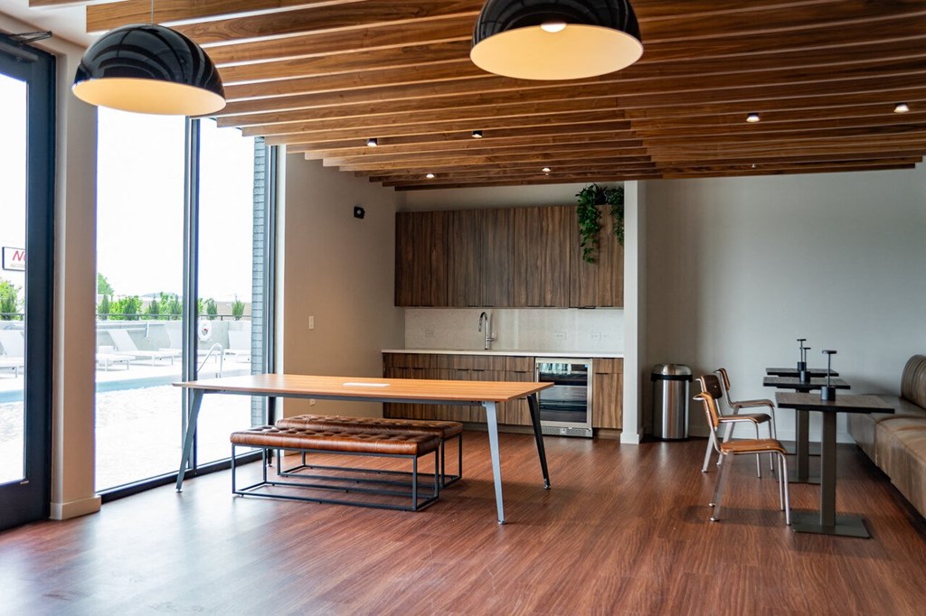 a dining area with a table and chairs in a room