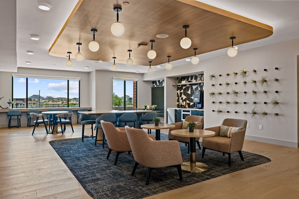 A modern dining room with a large table and chairs.