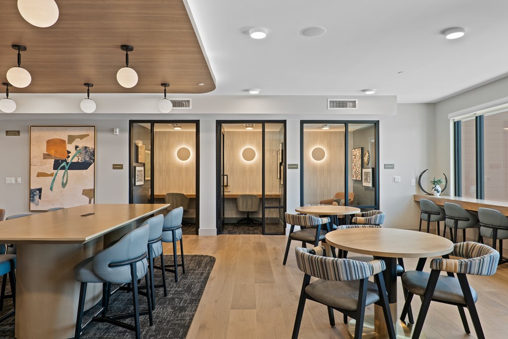 A modern dining area with a long table and chairs.