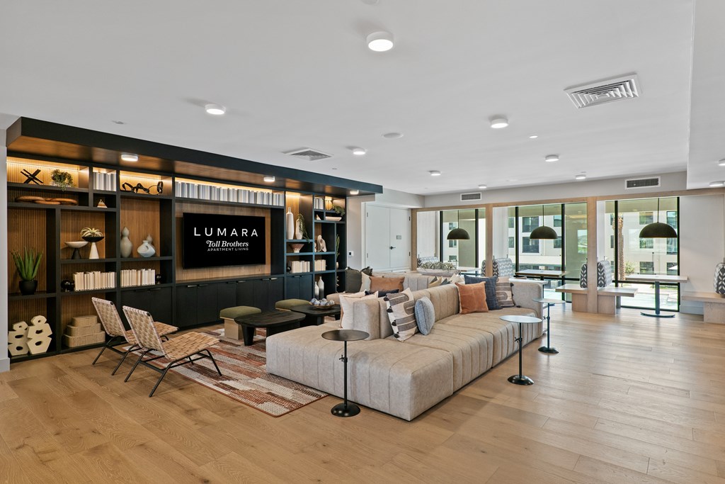 A modern living room with a Lumara sign on the wall.
