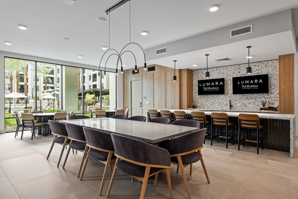 A modern dining room with a large table and chairs.