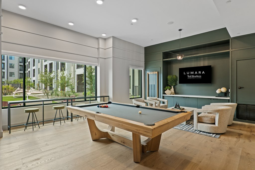 A pool table in a room with a sign that says