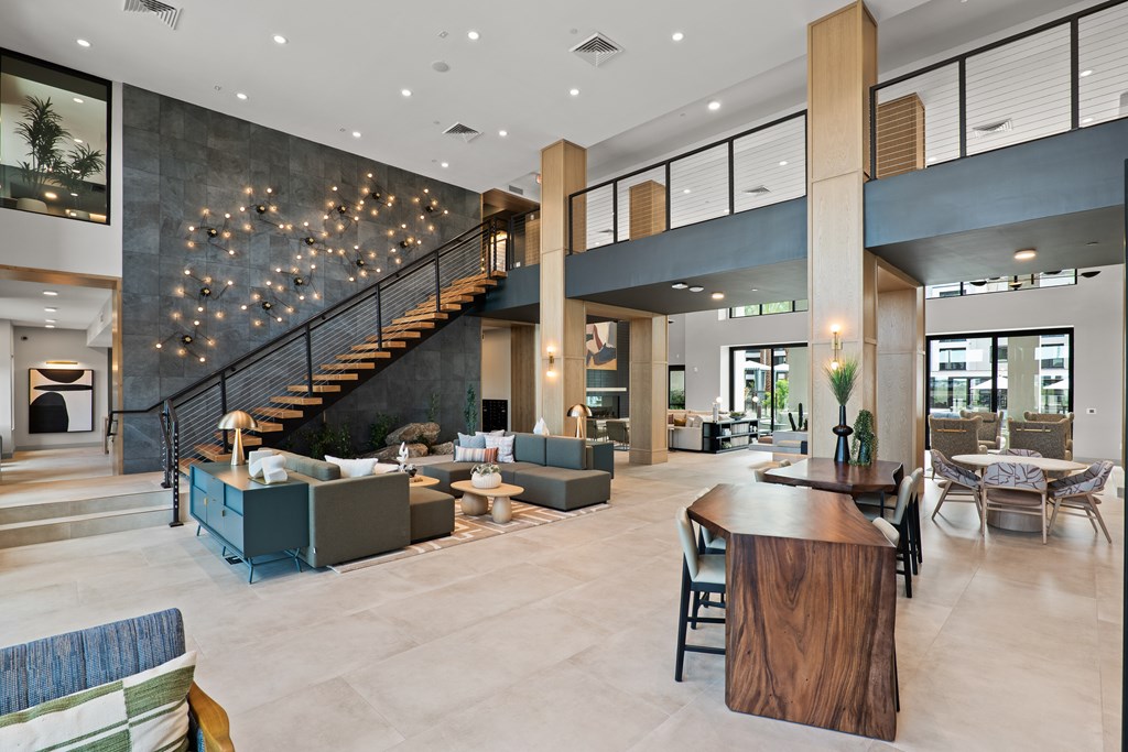 A large open space with a staircase and a bar.