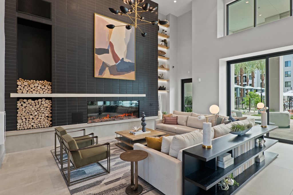 A modern living room with a fireplace and a painting on the wall.