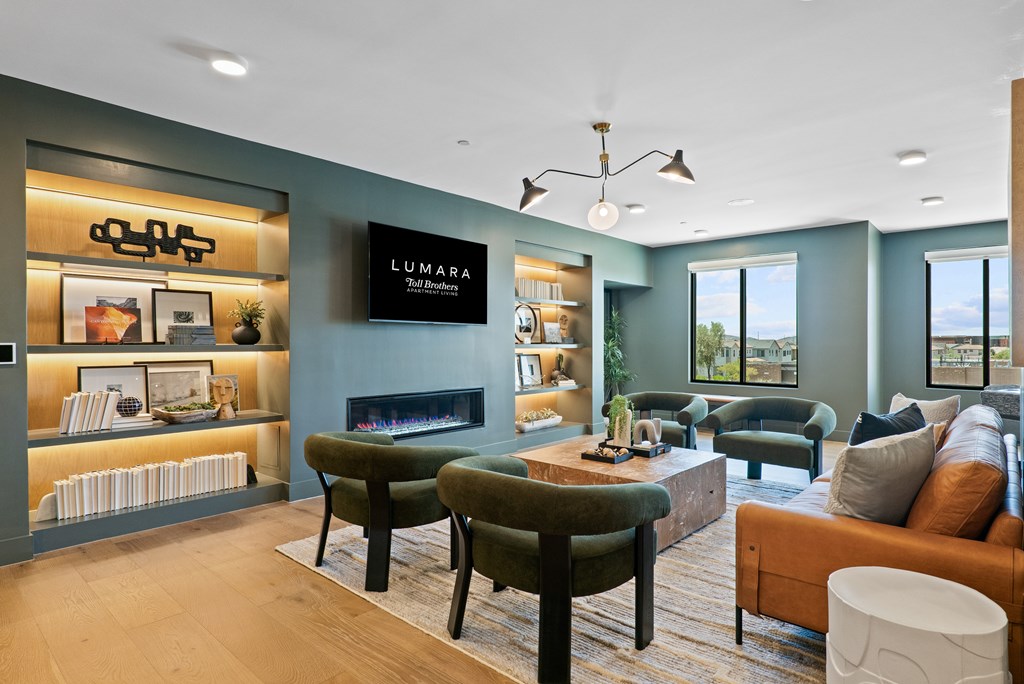 A modern living room with a green sofa and a fireplace.